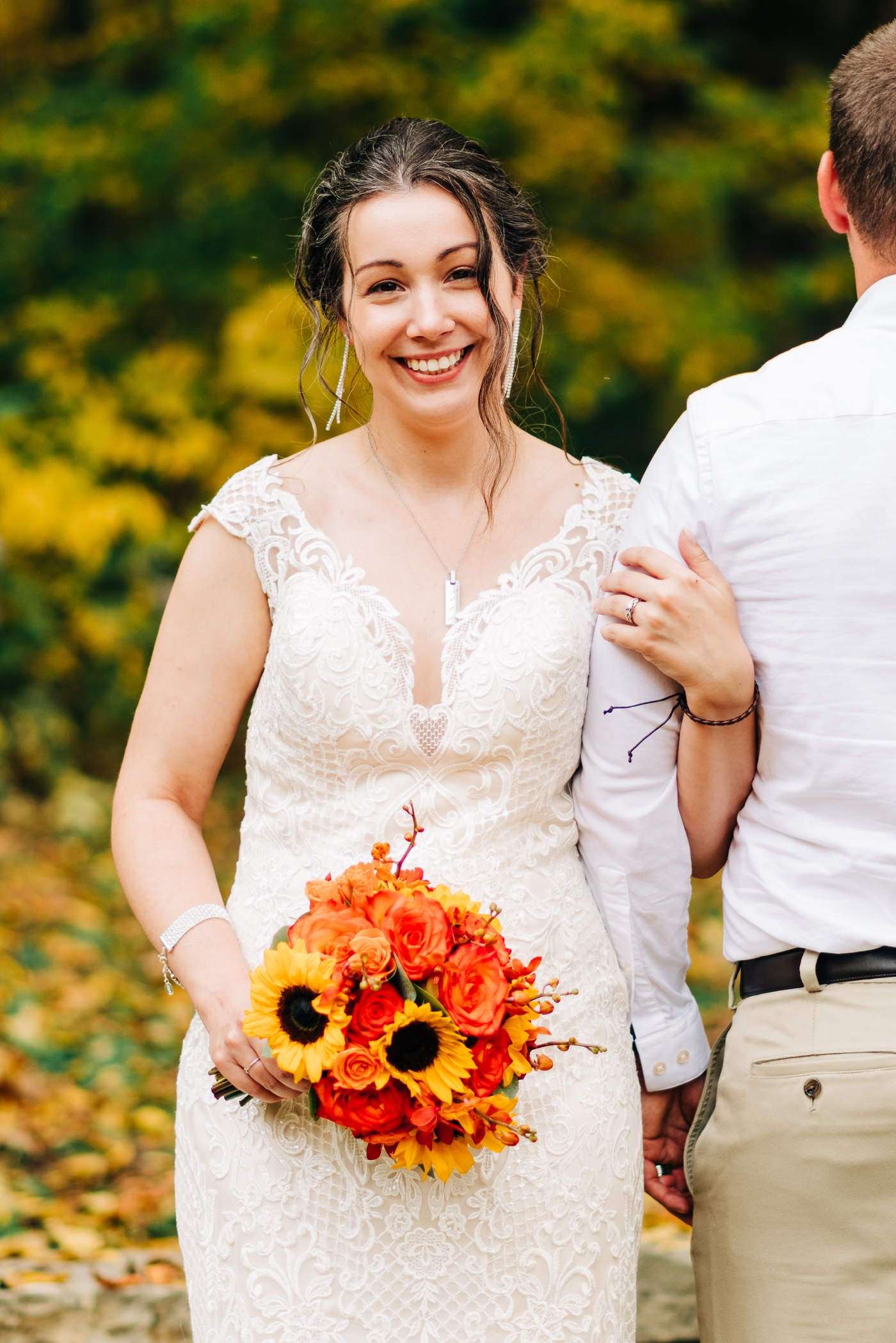 Bride with an orange flower and sunflower bouquet