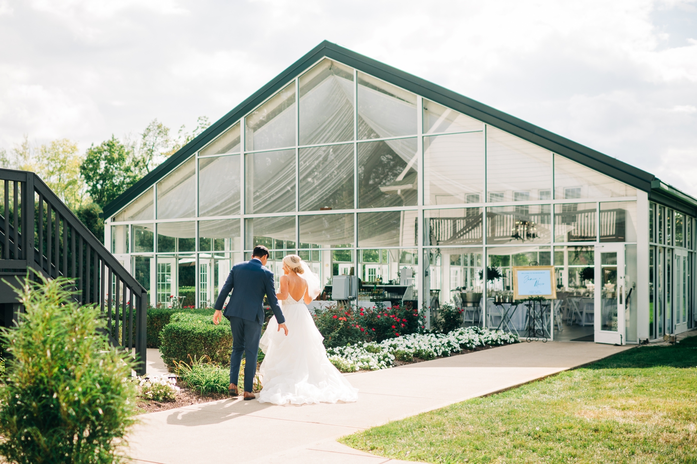 Bride and groom walking into Garden Pavilion for their wedding reception