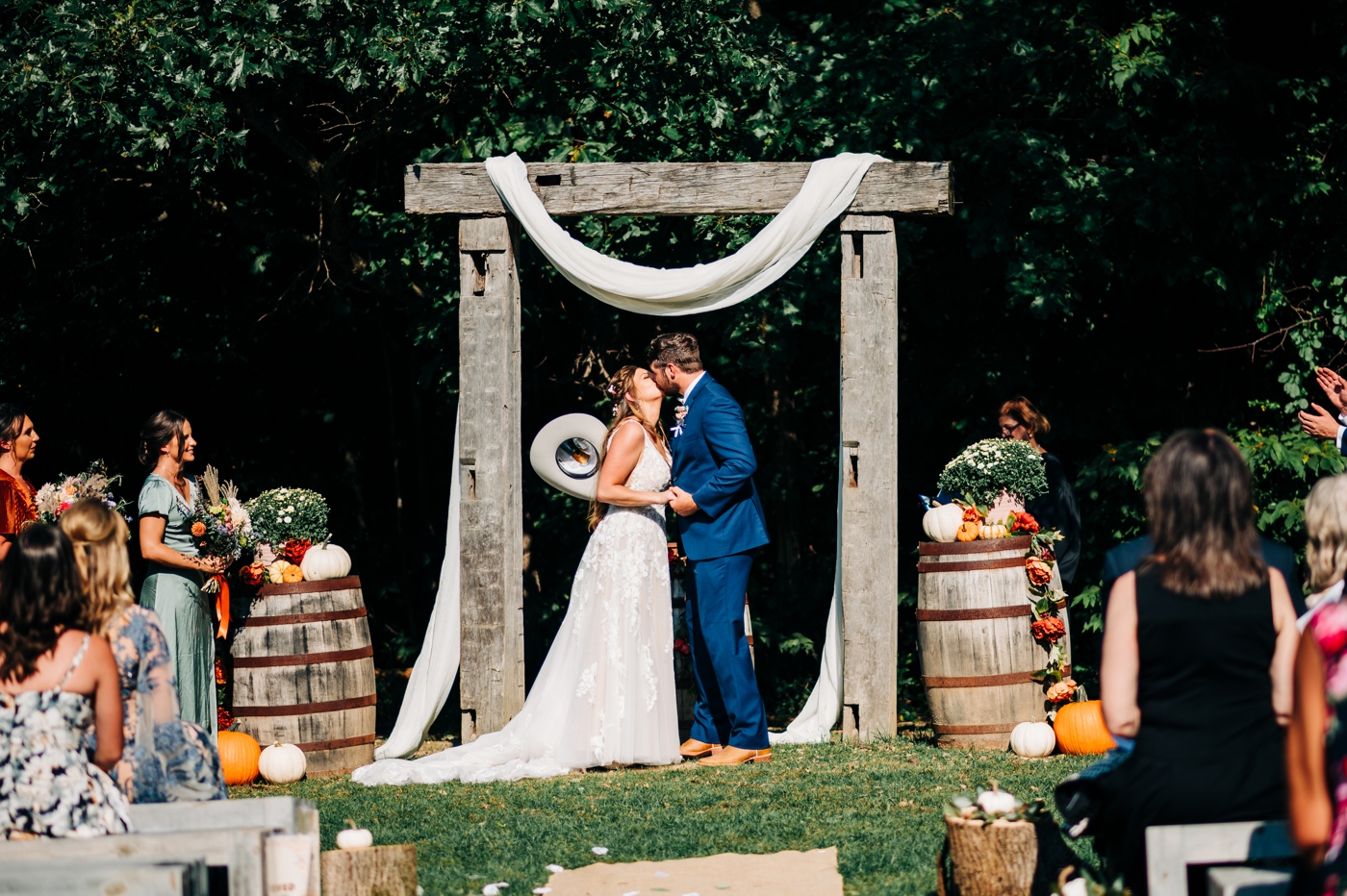 First kiss at rustic wedding ceremony at The Barn at Timber Ridge