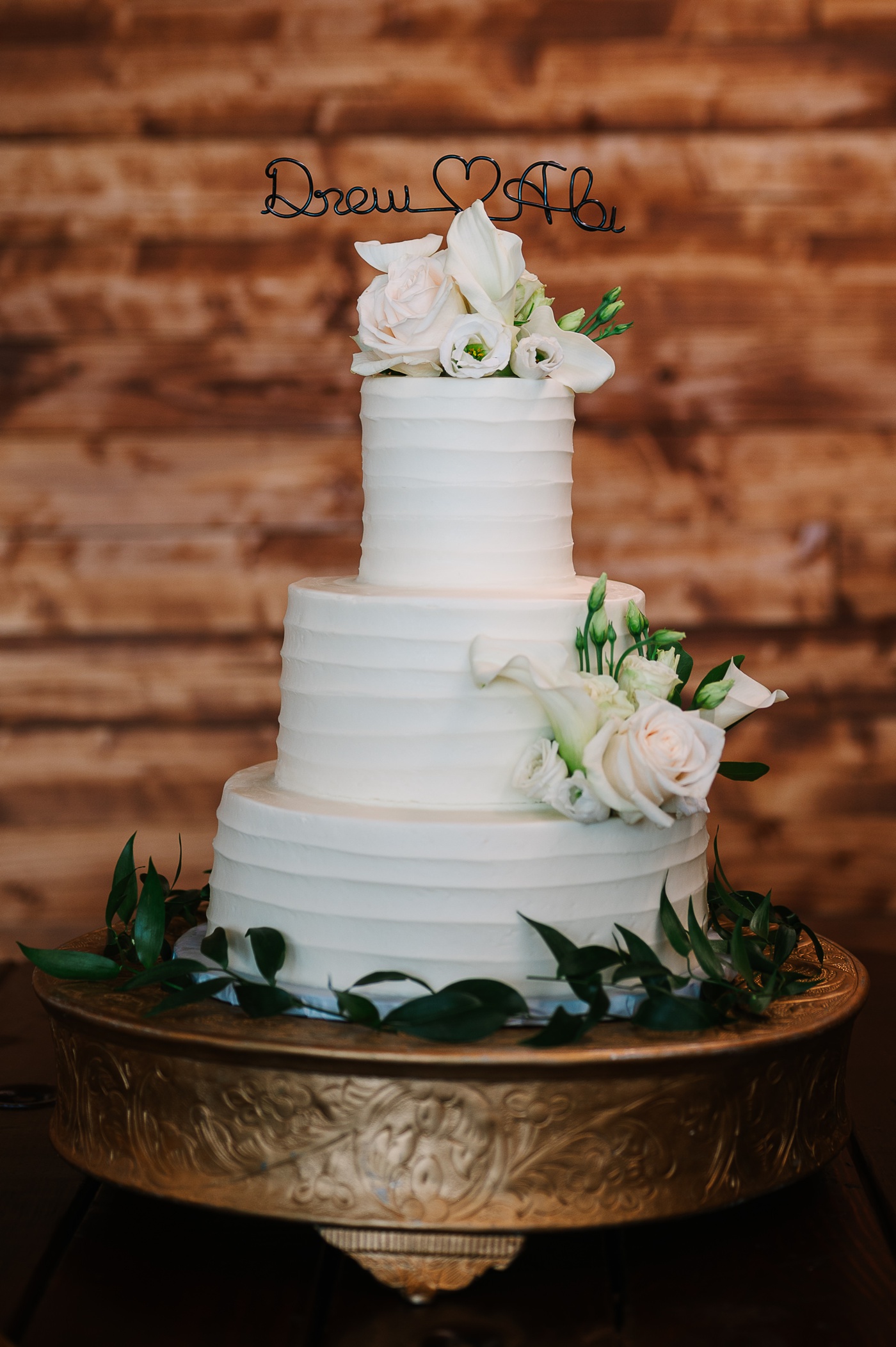 Ridged buttercream wedding cake with blush roses and greenery