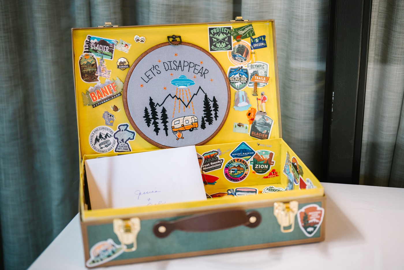 Wedding card box with a "Let's Disappear" embroidery hoop and National Park stickers
