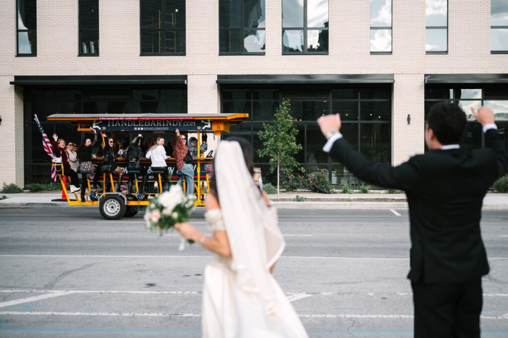 trolley cheering for bride and groom in downtown Indianapolis