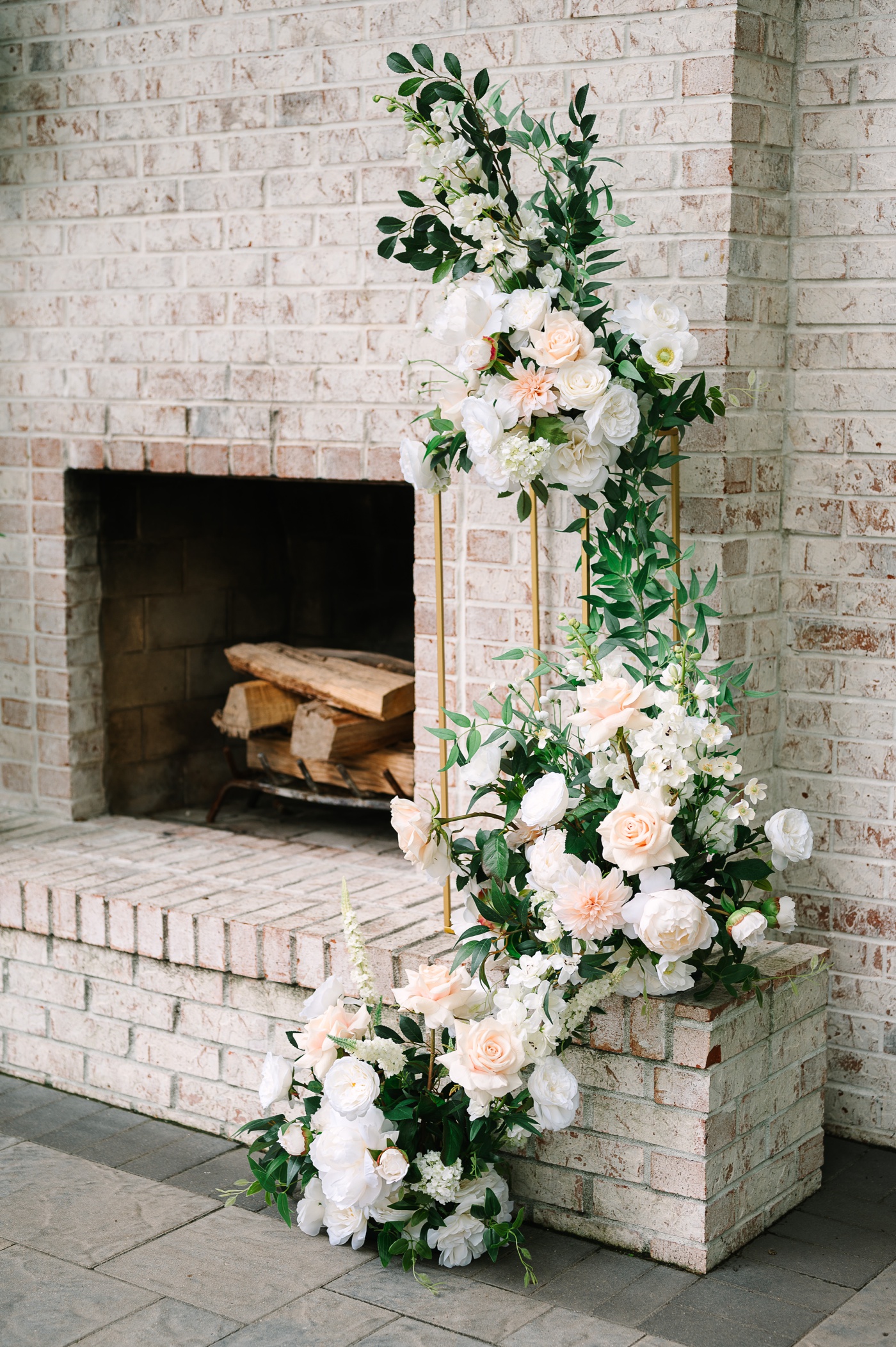 Blush dahlias and roses on a tall gold stand wedding altar décor