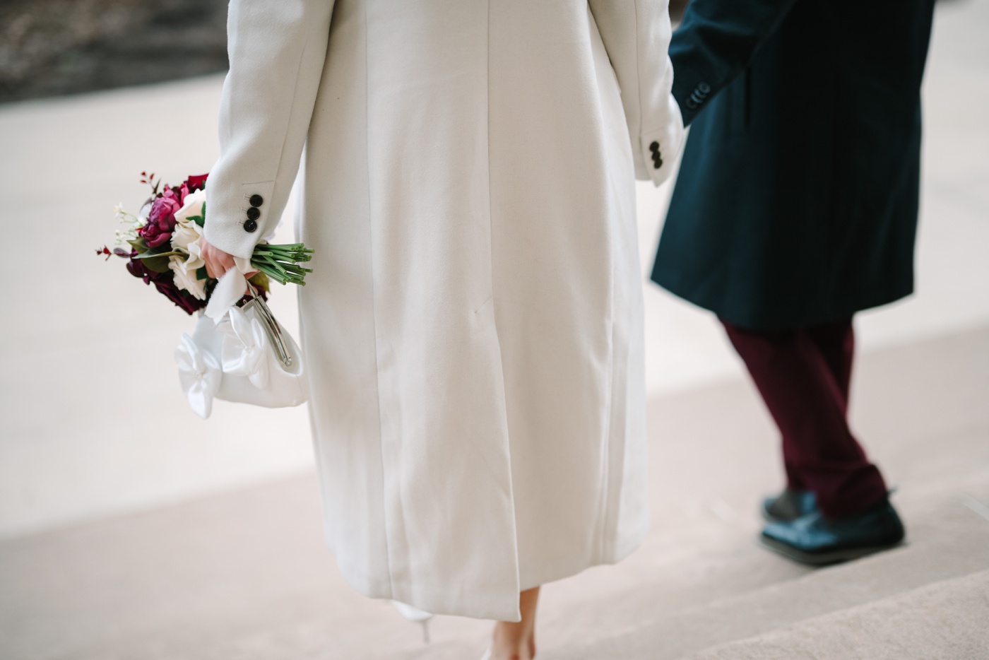 Bride and groom walking down the courthouse steps from behind