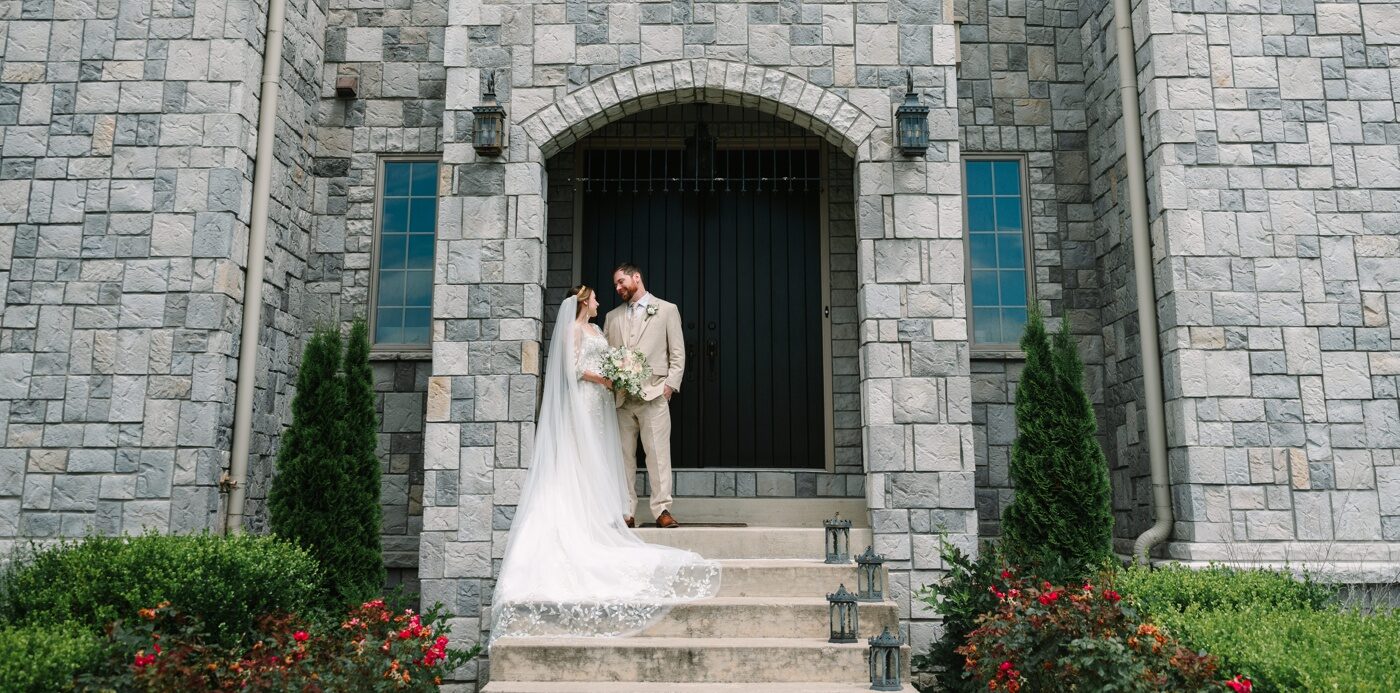 Bride and groom on the front steps at Clayshire Castle