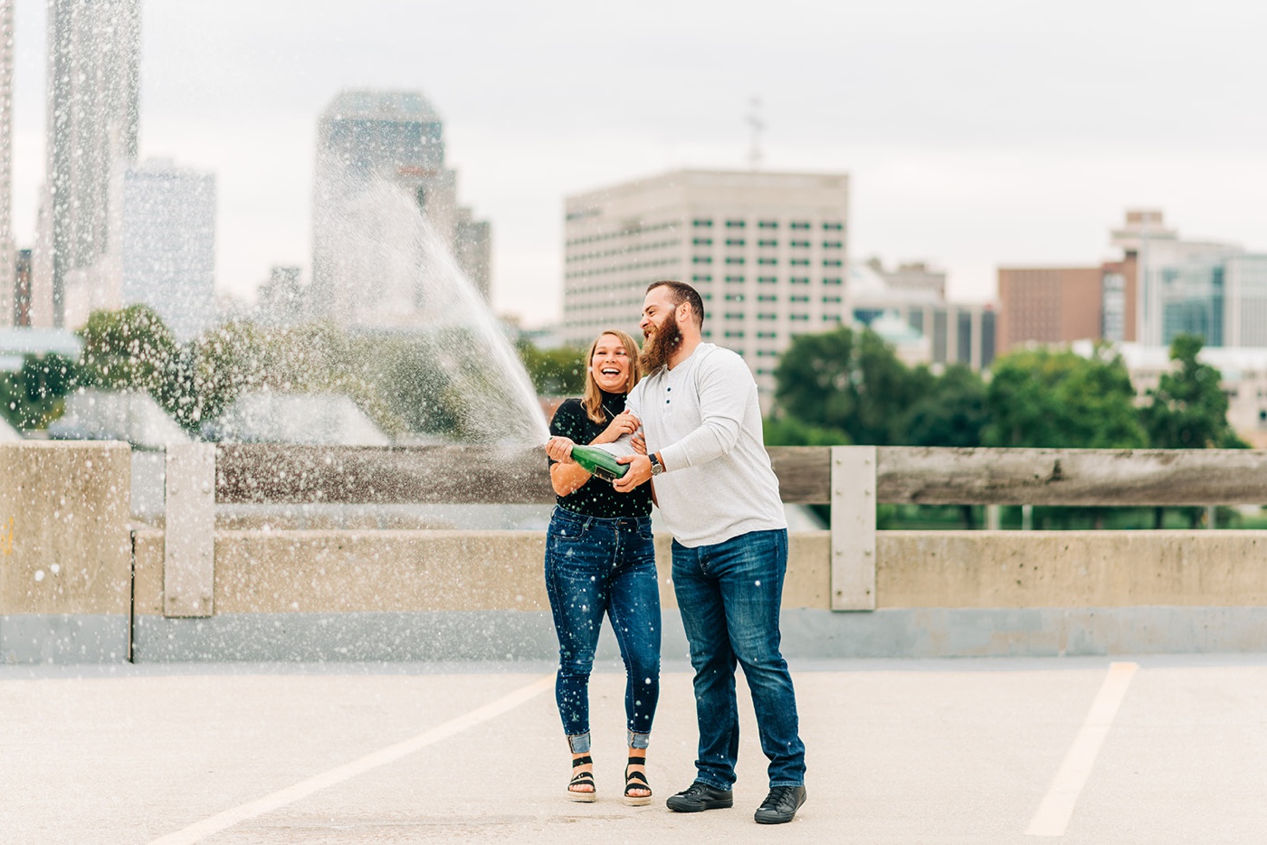 Couple spraying champagne on a rooftop in Indianapolis