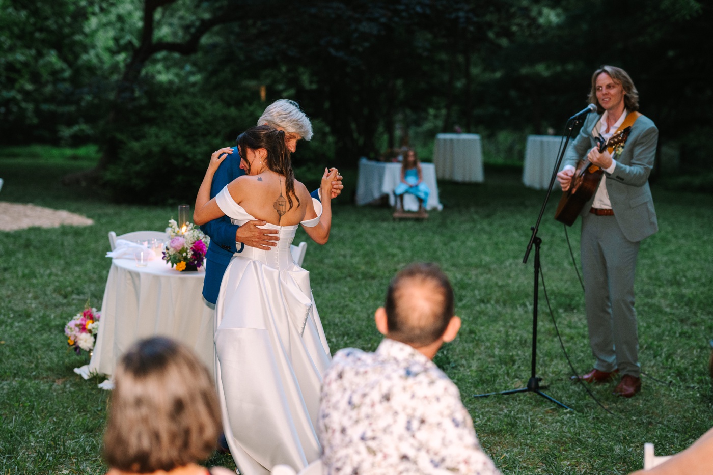 Groom playing guitar during father-daughter dance