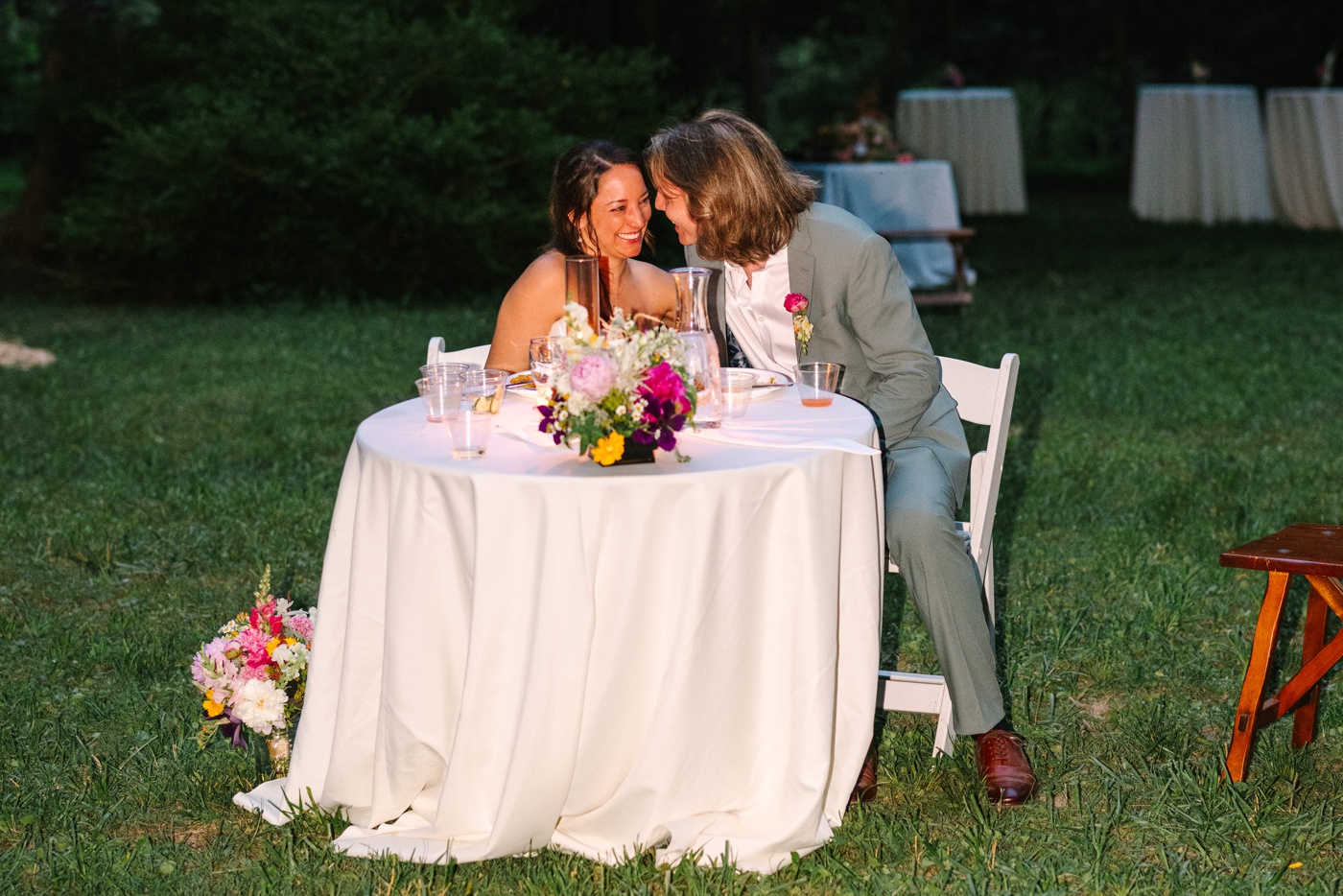 Bride and groom sitting at sweetheart table