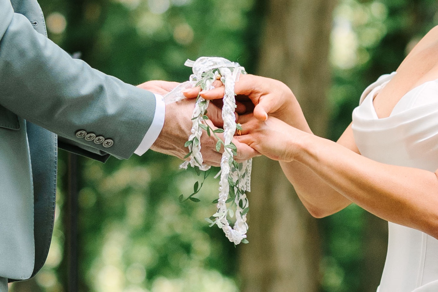 Bride and groom doing handfasting ceremony