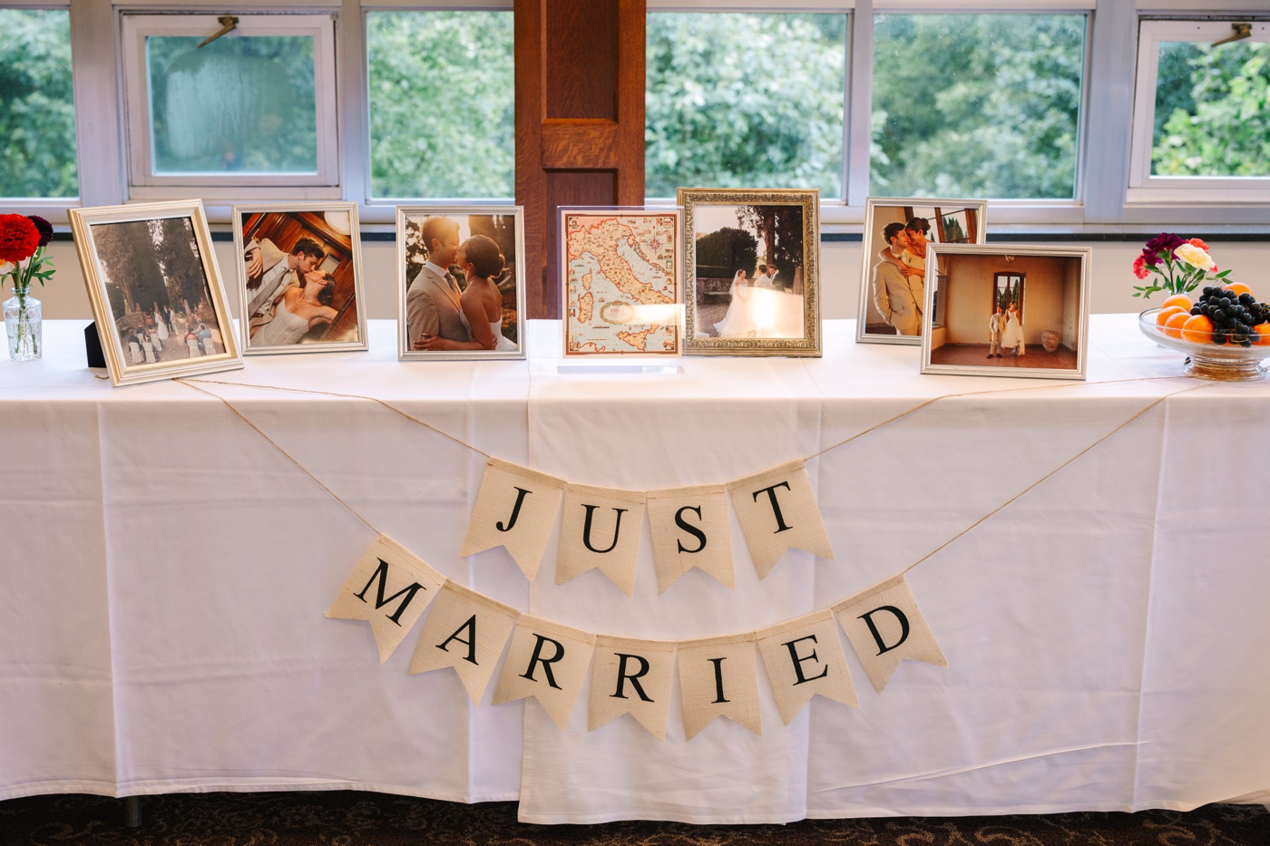 Table with framed wedding ceremony photos at an IU Alumni Hall reception